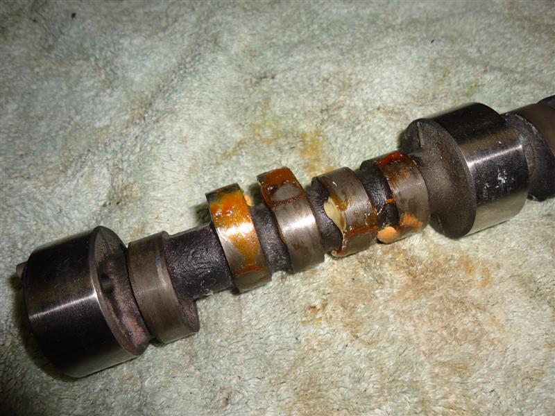 Old camshaft removed from small block 327 Chevy engine disassembly 327 camshaft