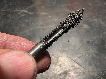 thread chaser or tap to clean dirty bolt threads