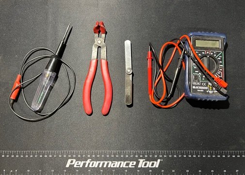 test light and insulated pliers along with feeler gauge and digital multimeter