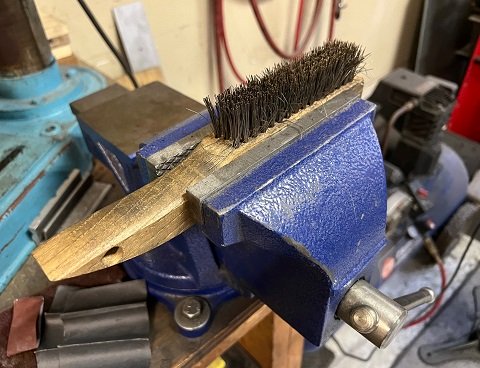 cleaning bolt threads with wire brush wire brush in vise